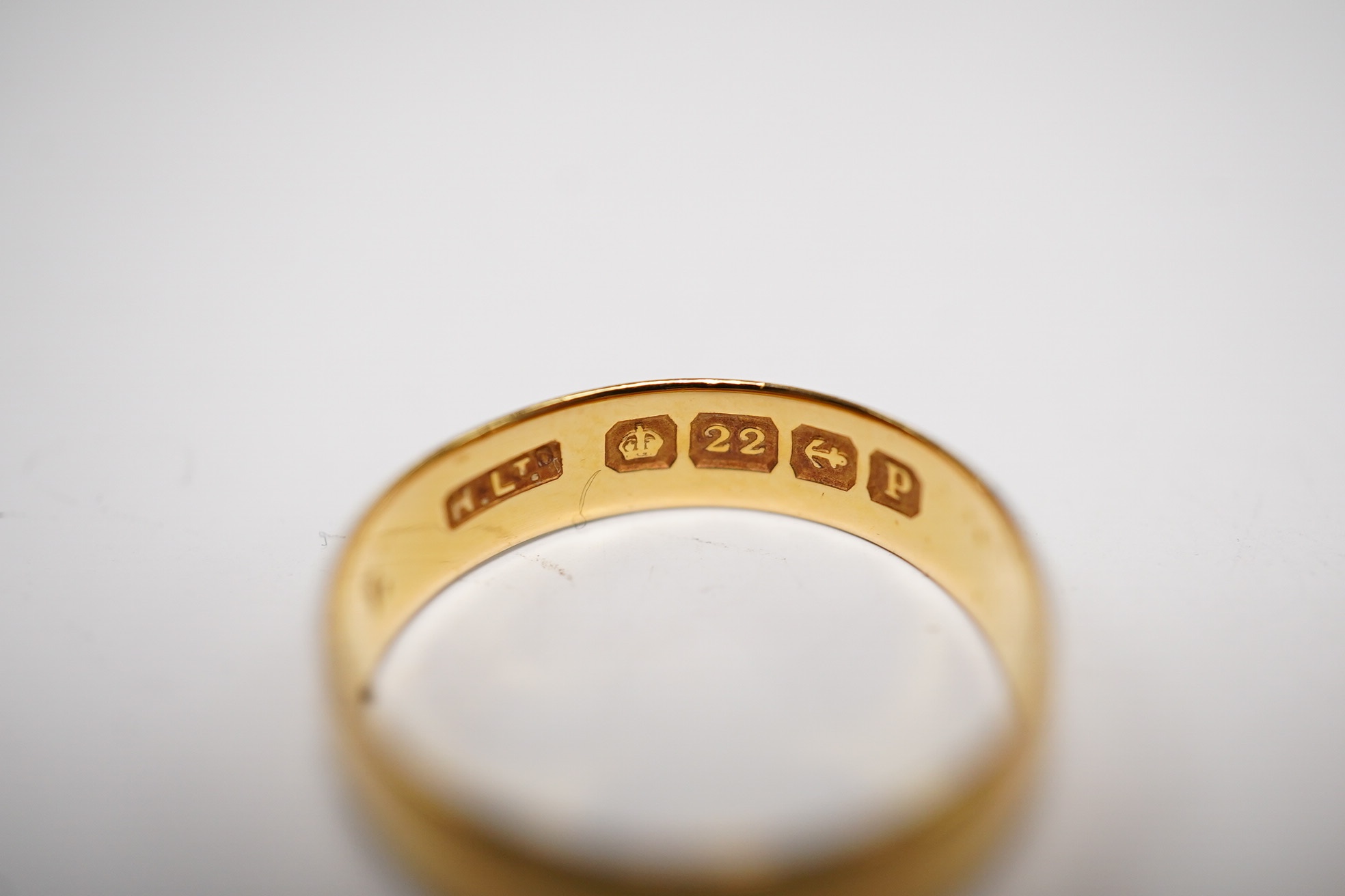 A 22ct gold wedding band, 2.6 grams, a yellow metal and solitaire diamond set ring and two 9ct gold rings including a signet ring, gross weight 9.3 grams. Condition - poor to fair